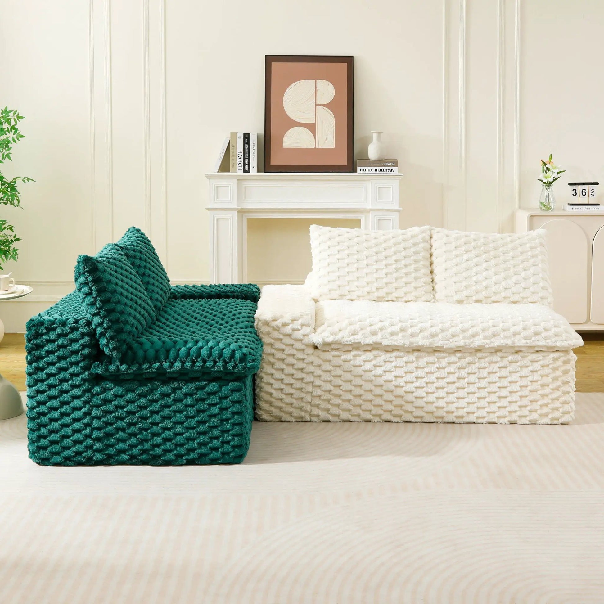 White and teal chunky knit cushions and throws on a light living room floor by white mantel on Tampa Home & Garden Store