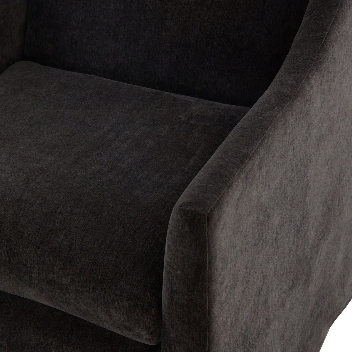 Skirted swivel accent chair in dark charcoal fabric with curved arm detailing on Tampa Home & Garden Store