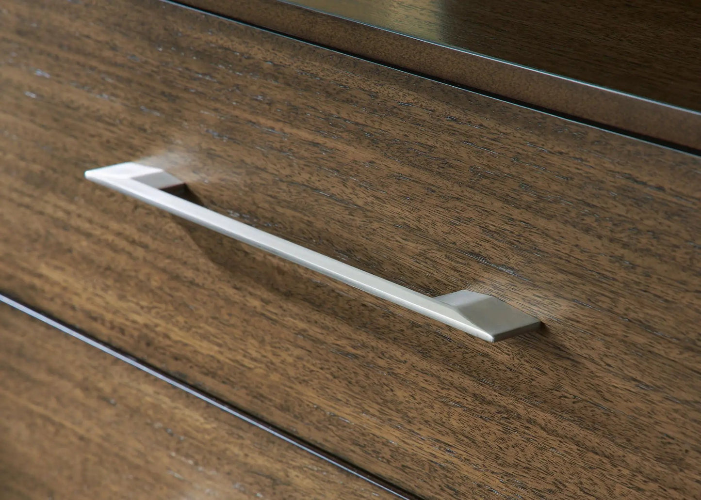 Dresser drawer front in dark wood with a long silver metal handle on Tampa Home & Garden Store