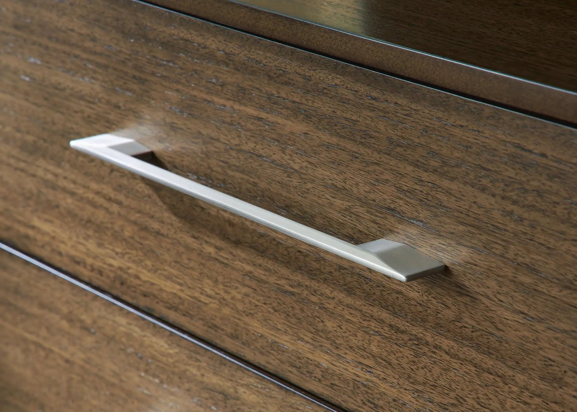 Dresser drawer front in dark wood with a long silver metal handle on Tampa Home & Garden Store