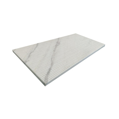 Textured white marble decorative tile with subtle gray veining and grooved surface on Tampa Home & Garden Store