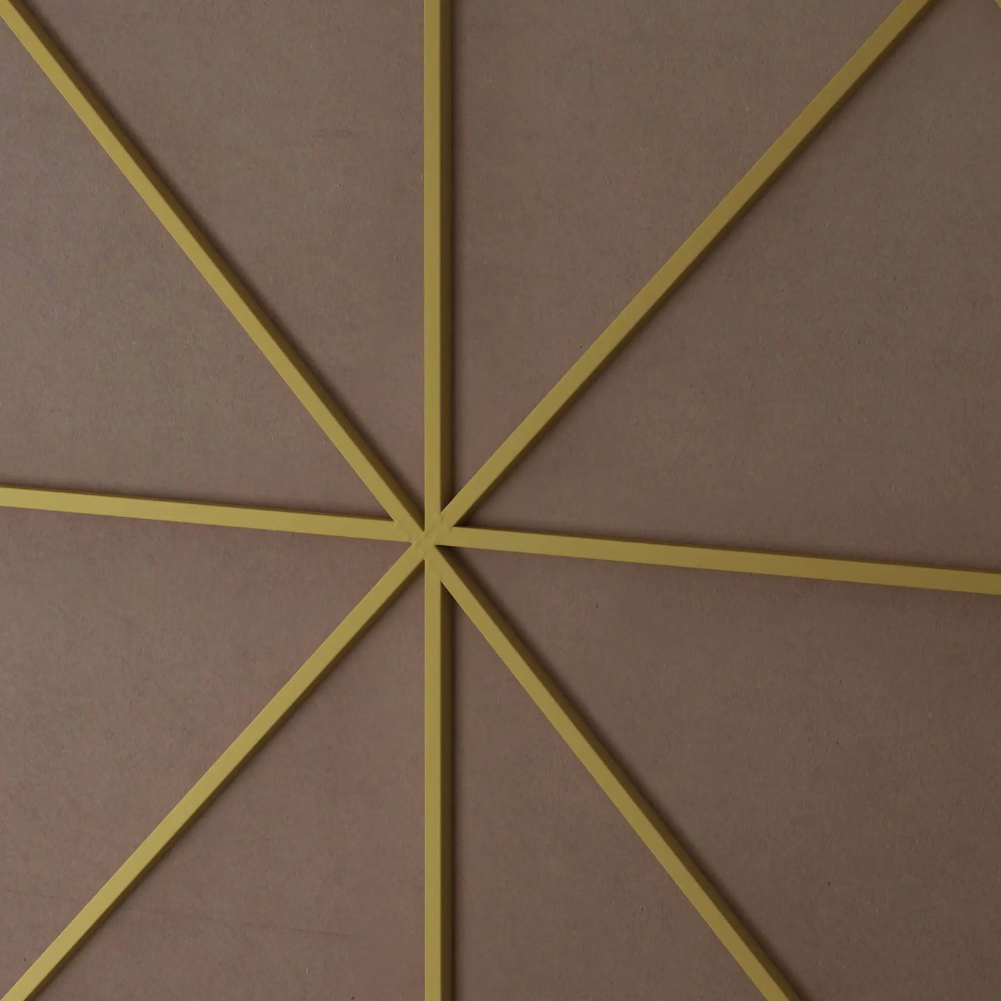 Wall mirror with yellow metal frame in a geometric diamond layout on pink textured wall on Tampa Home & Garden Store