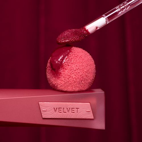 3CE Velvet Lip Tint Plush 4g crimson red lip tint on glossy applicator above velvet pink ball on Tampa Home & Garden Store