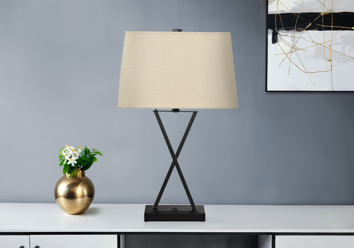 Table lamp with black metal X-base and beige fabric shade, transitional style on Tampa Home & Garden Store