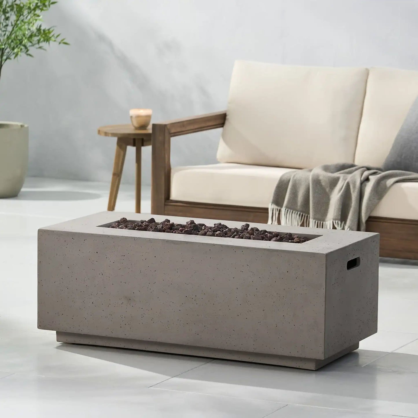 Fire pit concrete rectangular unit with lava rocks in a modern outdoor lounge on Tampa Home & Garden Store