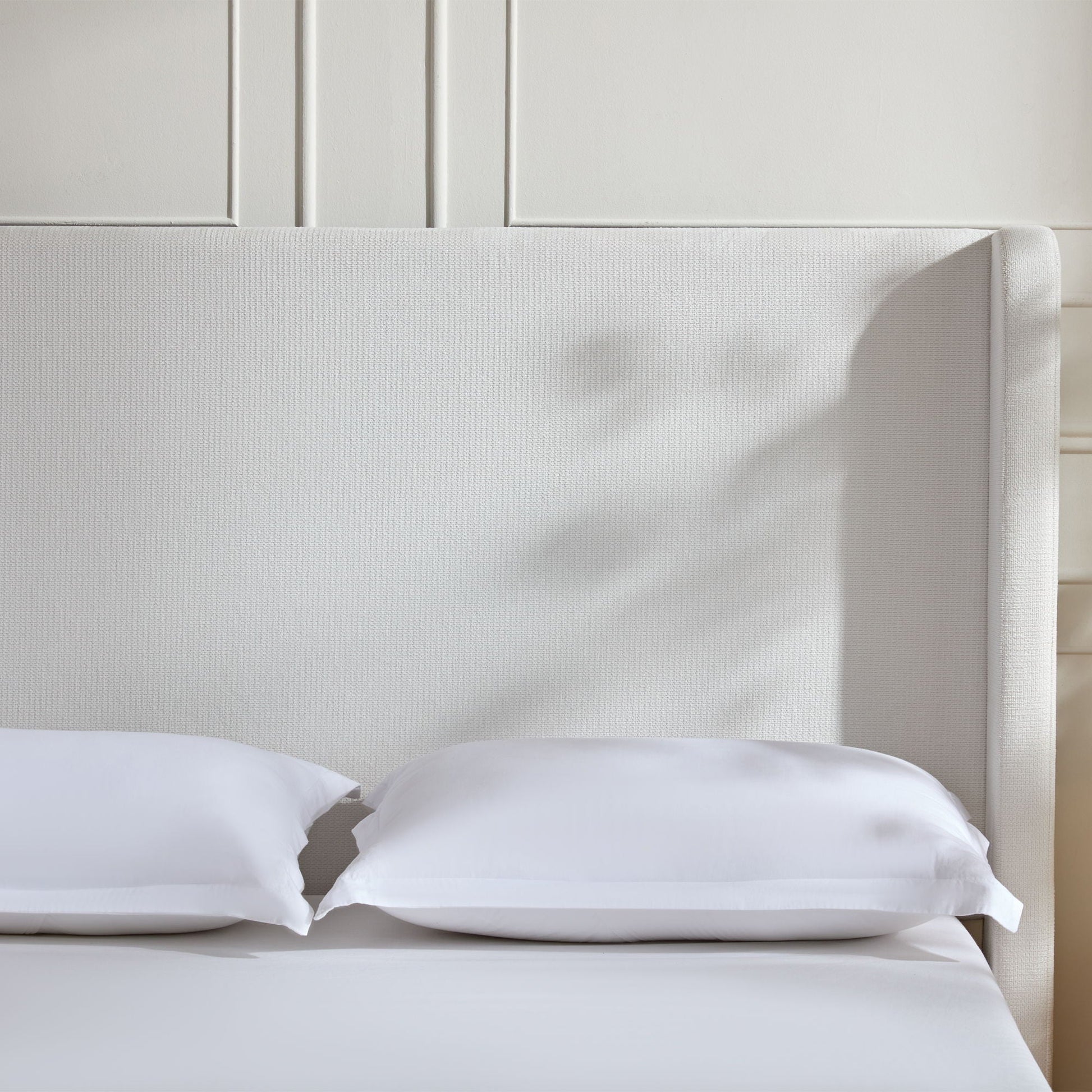 Harper tall upholstered bed with cream fabric headboard and white bedding on Tampa Home & Garden Store