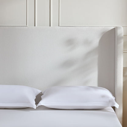 Harper tall upholstered bed with cream fabric headboard and white bedding on Tampa Home & Garden Store