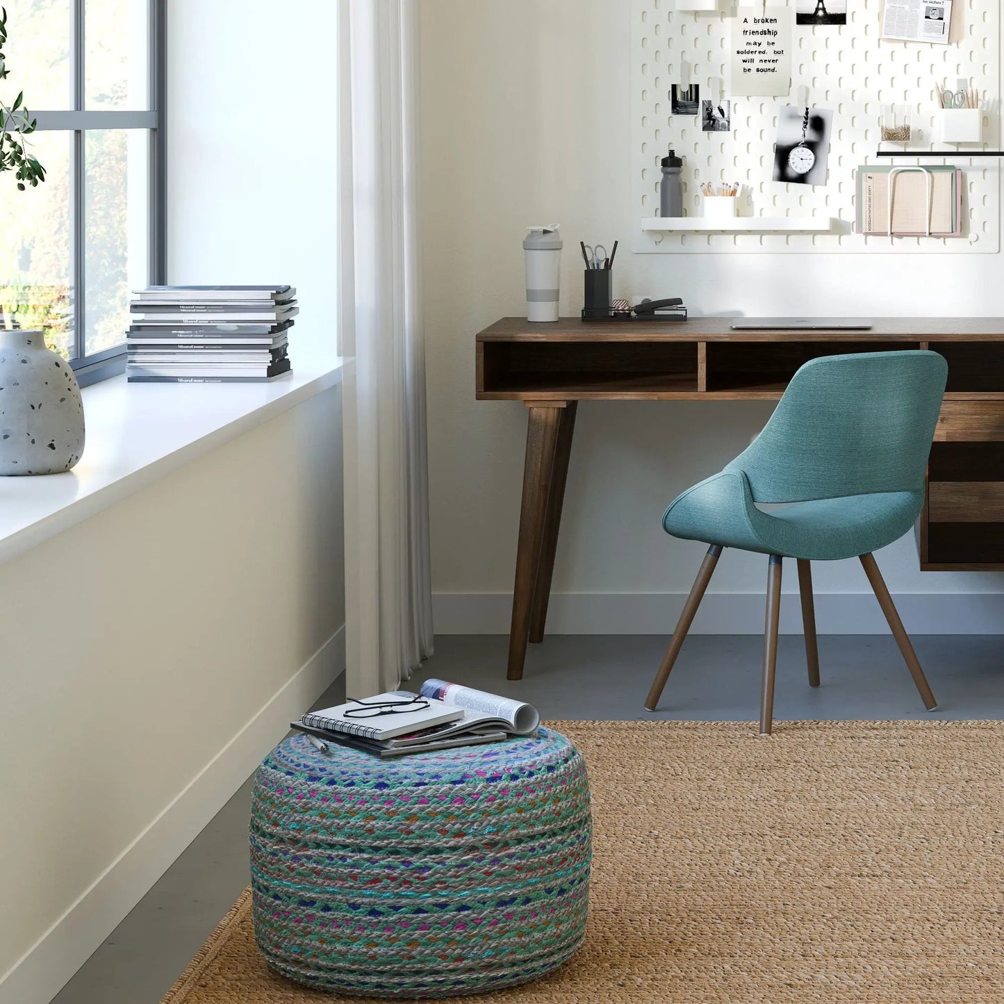 Margo handcrafted round poufs pair in teal multicolor woven fabric on a rug beside a desk on Tampa Home & Garden Store