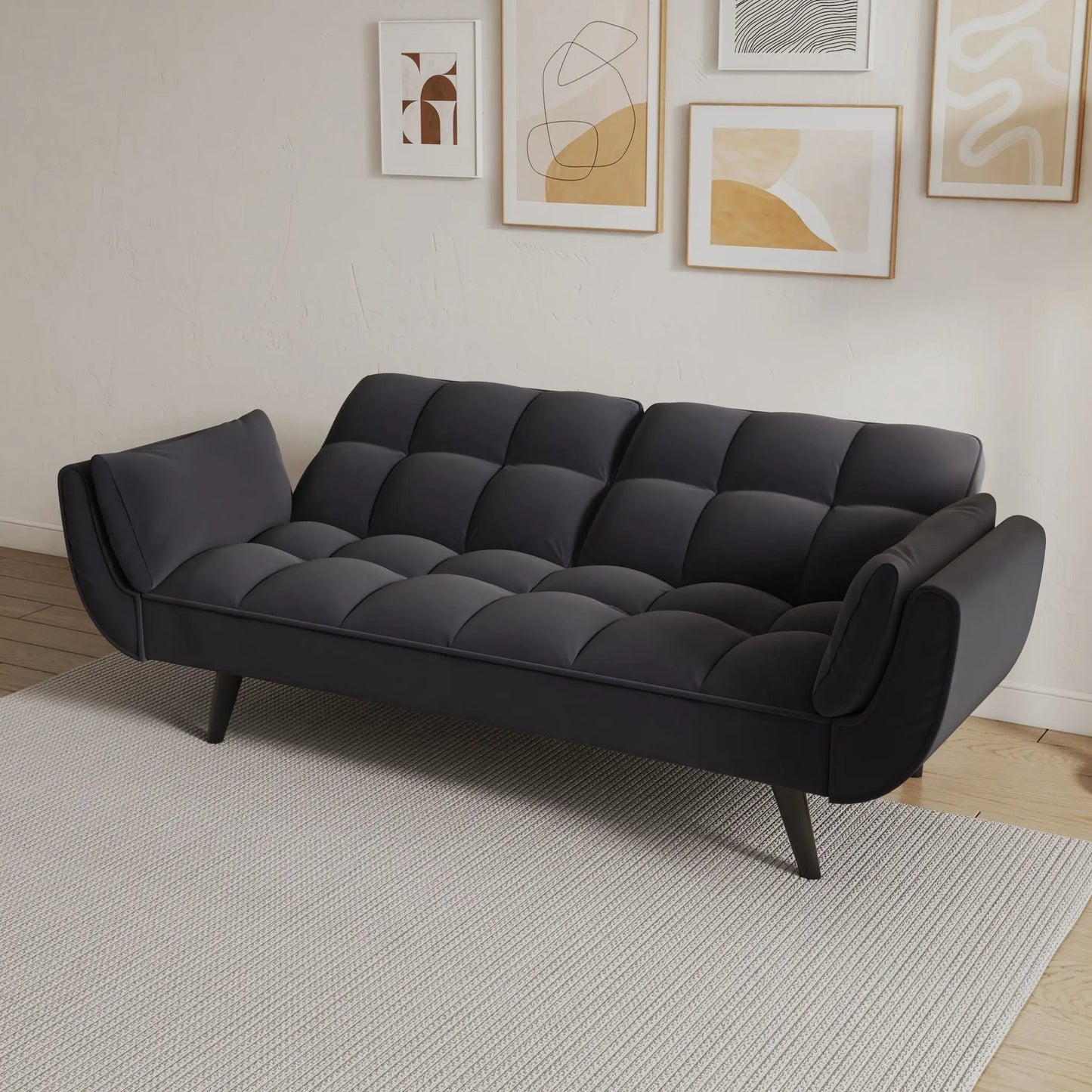 Dark gray tufted futon sofa with two armrests and plush cushions for small spaces on Tampa Home & Garden Store
