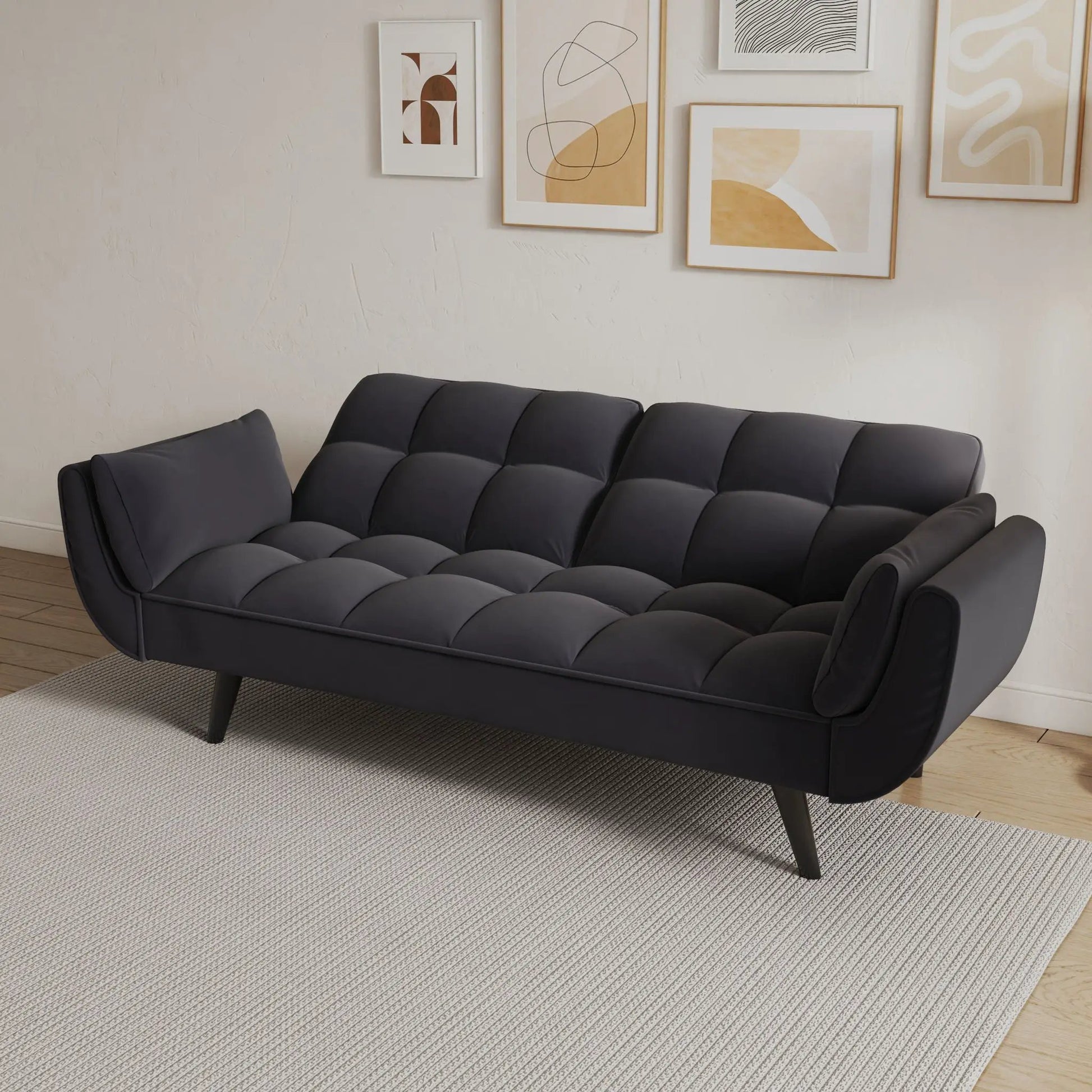 Dark gray tufted futon sofa with two armrests and plush cushions for small spaces on Tampa Home & Garden Store