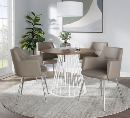 Contemporary dining table with round wood top and metal base, beige upholstered chairs on Tampa Home & Garden Store
