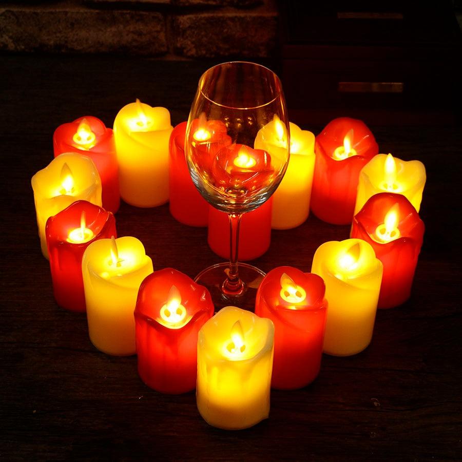3pc LED flameless candle set in red and yellow surrounding a wine glass on a dark table on Tampa Home & Garden Store