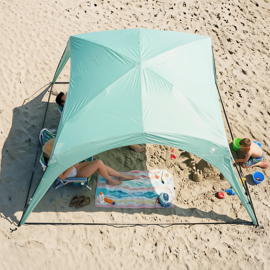 Pop 'N Go® Canopy aqua beach shelter by The California Beach Company LLC on sandy beach on Tampa Home & Garden Store