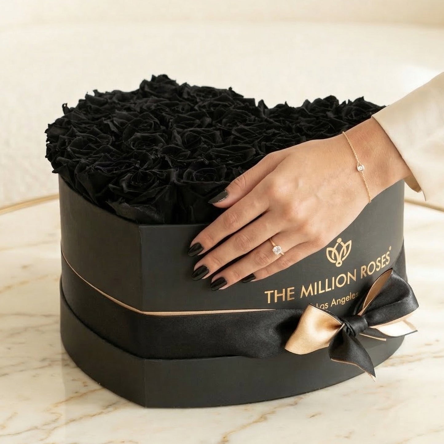 Heart Black Box filled with black roses by The Million Roses, hands cradle the gift on Tampa Home & Garden Store