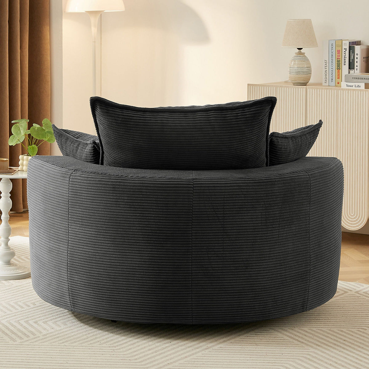 Swivel barrel chair with cushion and pillows in black ribbed upholstery, round lounge seat on Tampa Home & Garden Store
