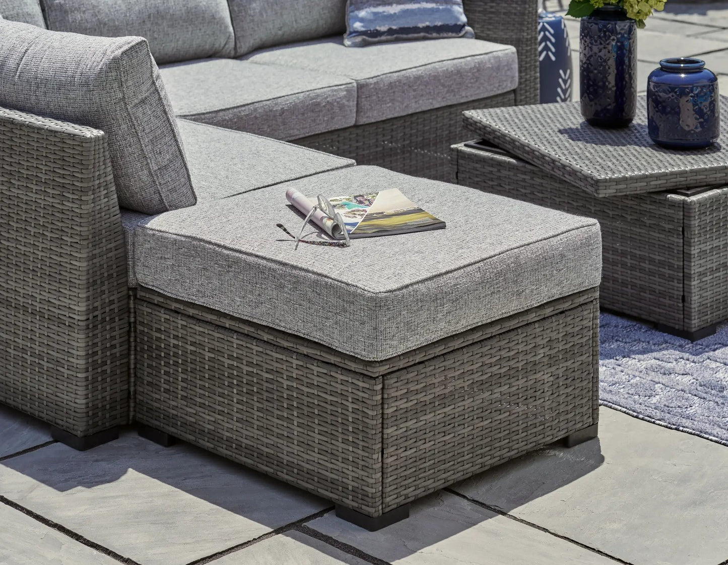 Petal Road gray outdoor wicker 4-piece set with loveseat, ottoman, and coffee table on a patio on Tampa Home & Garden Store