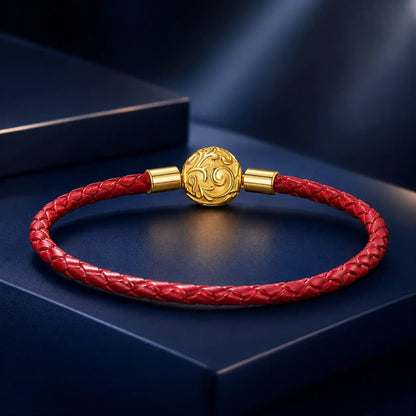 Red braided leather rope bracelet with gold-tone ornate central bead and gold end caps on Tampa Home & Garden Store