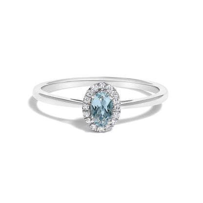 Ring with oval blue gemstone surrounded by a diamond halo on a white gold band on Tampa Home & Garden Store