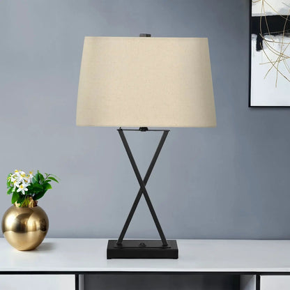 Table lamp black metal tripod base with beige fabric shade on Tampa Home & Garden Store