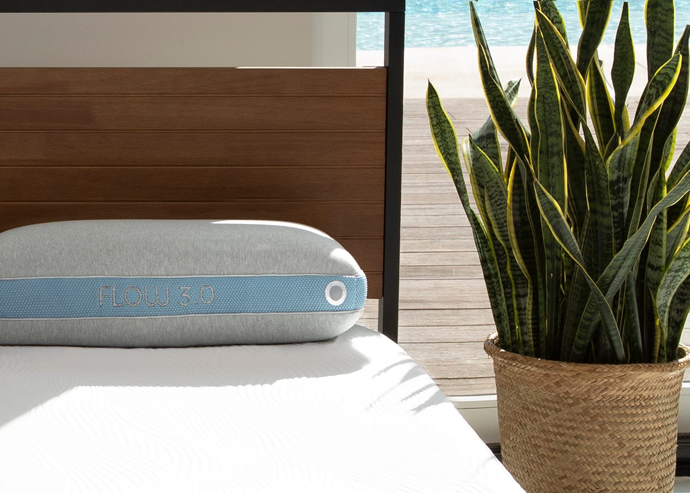 BedGear Flow Performance Pillow gray with blue strap FLOW 3.0 on bed beside a potted plant on Tampa Home & Garden Store