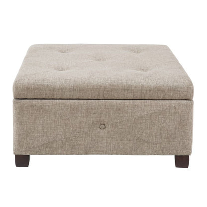 Aspen storage ottoman in light brown upholstery with tufted top and dark wood legs on Tampa Home & Garden Store