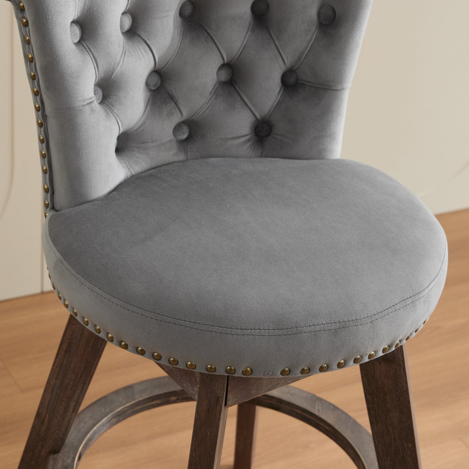 Counter-height velvet bar stool in grey with tufted back and brass nailhead trim on Tampa Home & Garden Store