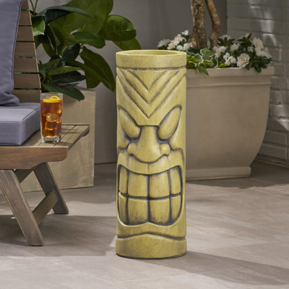 Stone statue urn planter with antique green finish and decorative face motif on a patio on Tampa Home & Garden Store