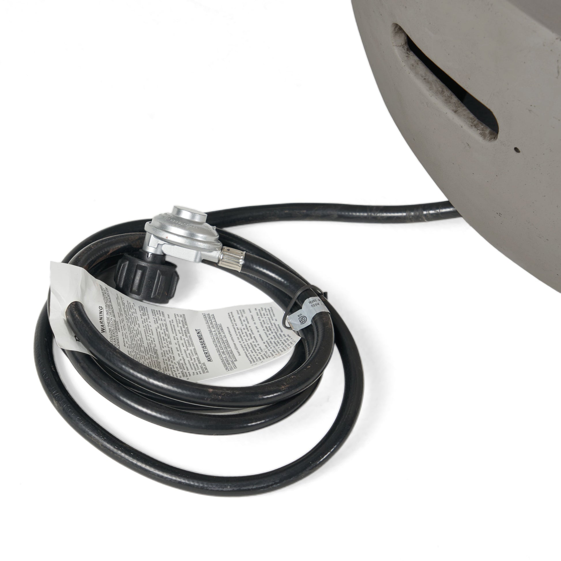 Fire pit gas hose and regulator with valve beside a light grey bowl edge, HouseOfZazla on Tampa Home & Garden Store