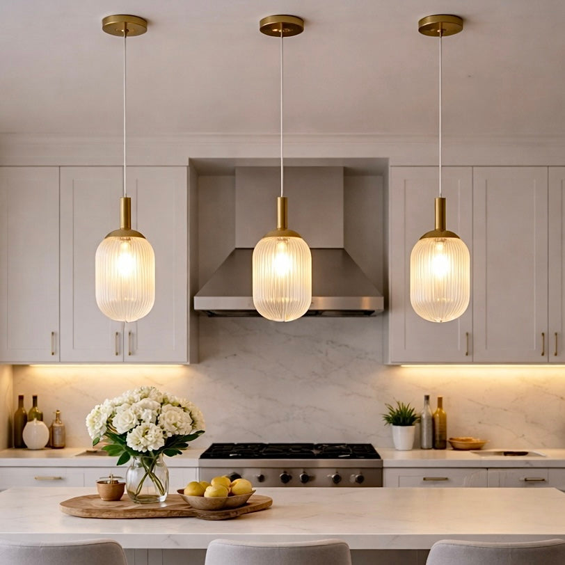 Modern Style Pendant Lamp Bronze and Clear, three ribbed glass shades over white marble island on Tampa Home & Garden Store