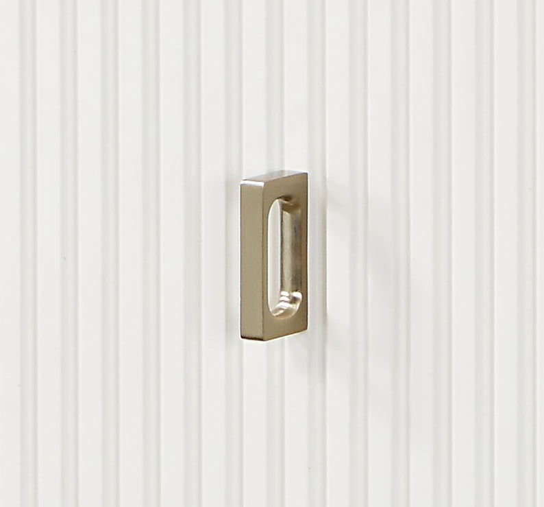 Carena Chest drawer pull in brass finish mounted on white beadboard panel on Tampa Home & Garden Store