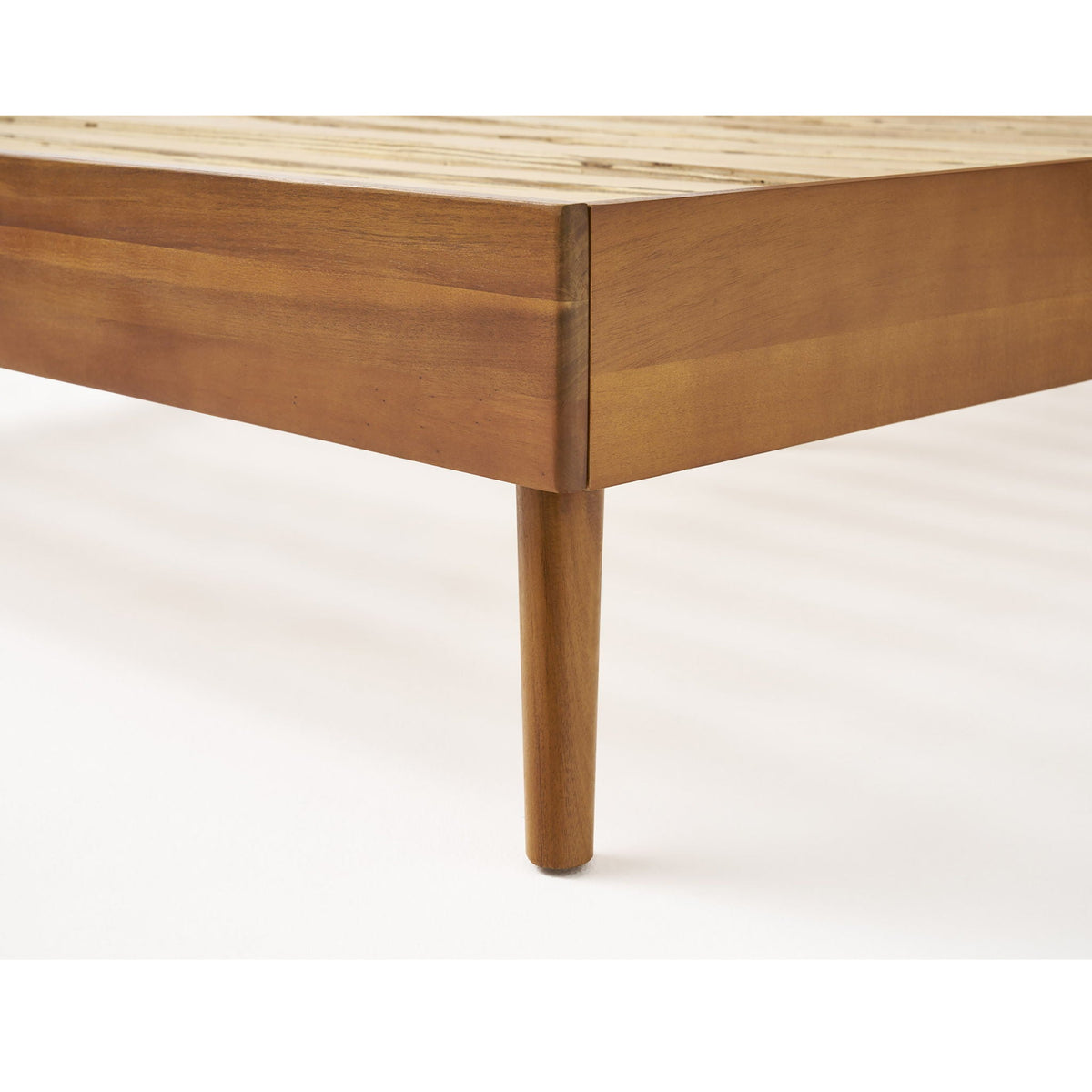 Mid-Century wood platform bed corner in light brown with visible slats and single leg on Tampa Home & Garden Store