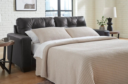 Barlin Mills sofa sleeper in black leather with beige knitted cover in a modern bedroom on Tampa Home & Garden Store