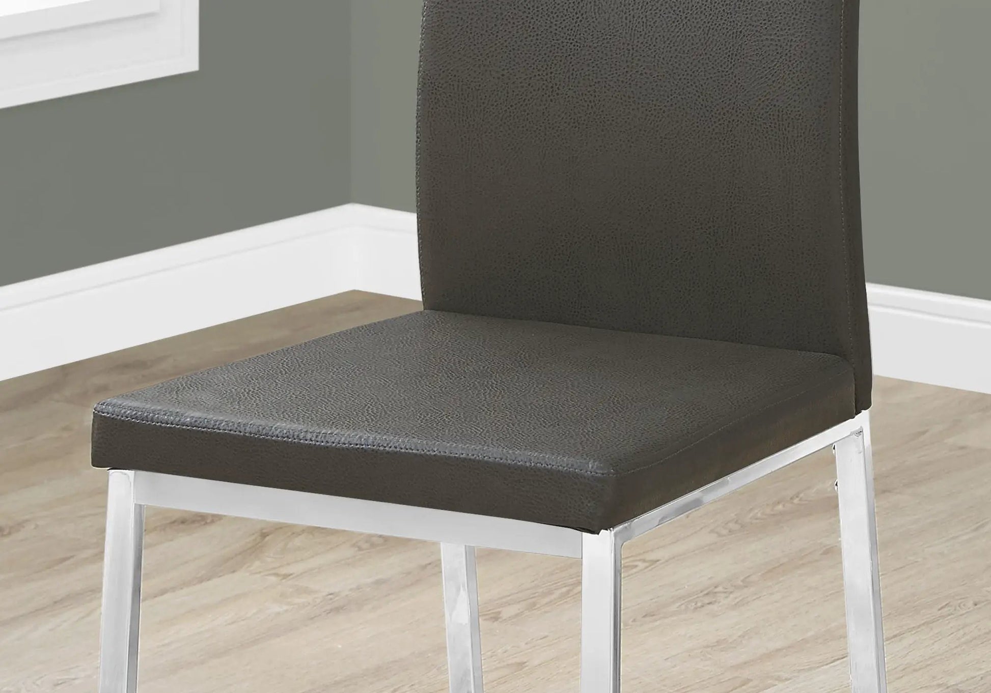 Dining side chair upholstered in dark grey faux leather with white metal frame on Tampa Home & Garden Store