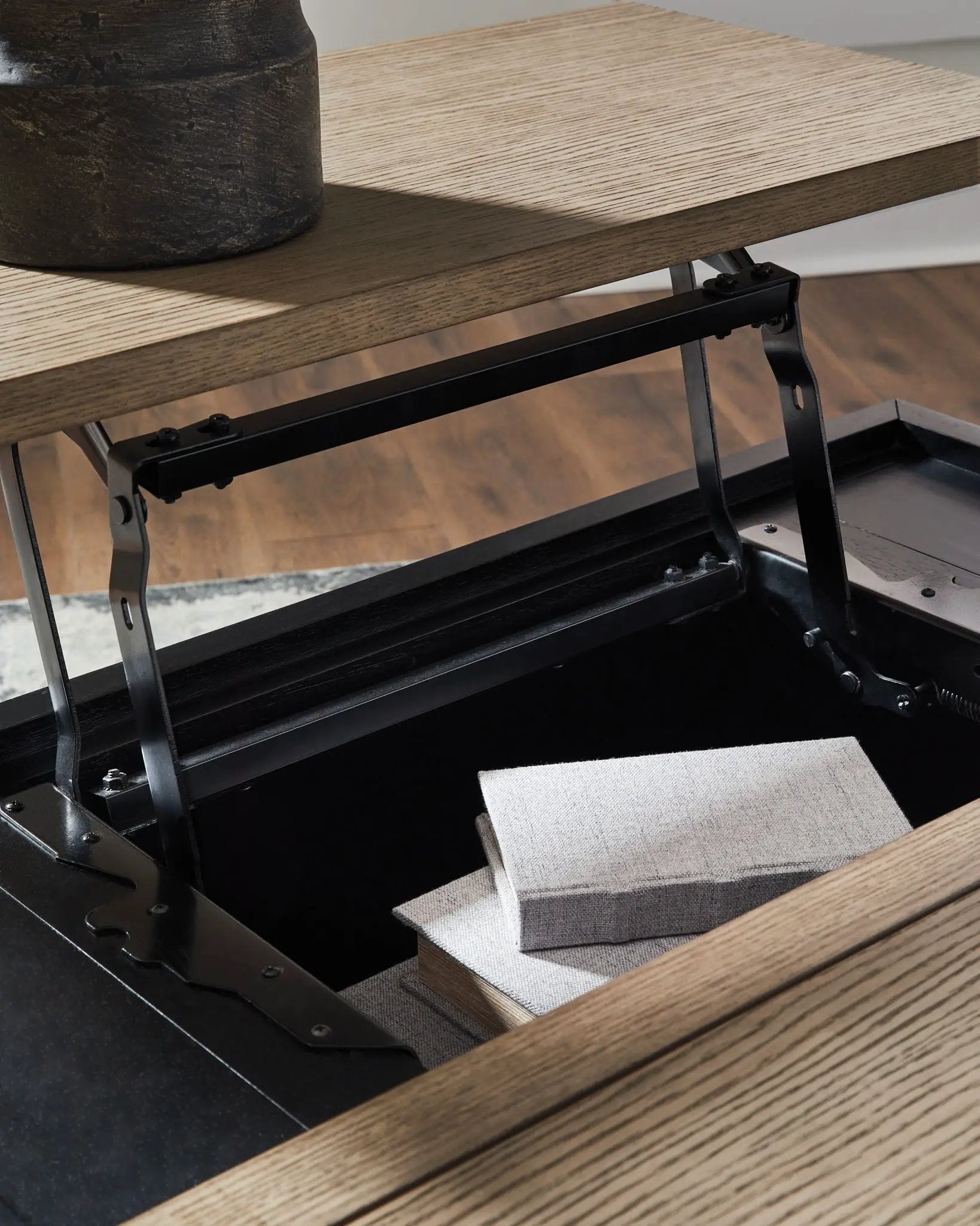 Rylandyn lift-top cocktail table with black metal frame and light brown wood top; cushions on Tampa Home & Garden Store