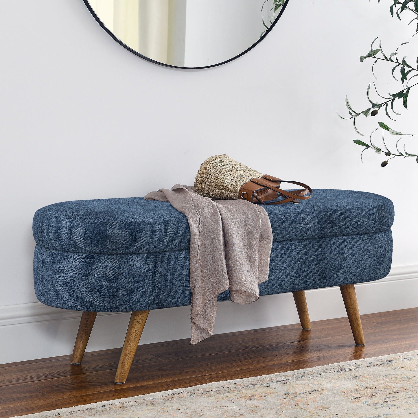 Modern oval storage bench in blue fabric with rubber wood legs, scarf and bag on Tampa Home & Garden Store