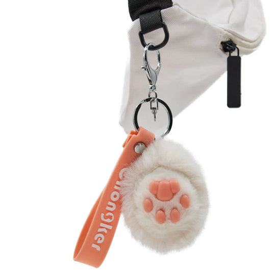 Cat paw keychain by Chongker with fluffy white fur and orange paw pads with silver metal ring on Tampa Home & Garden Store