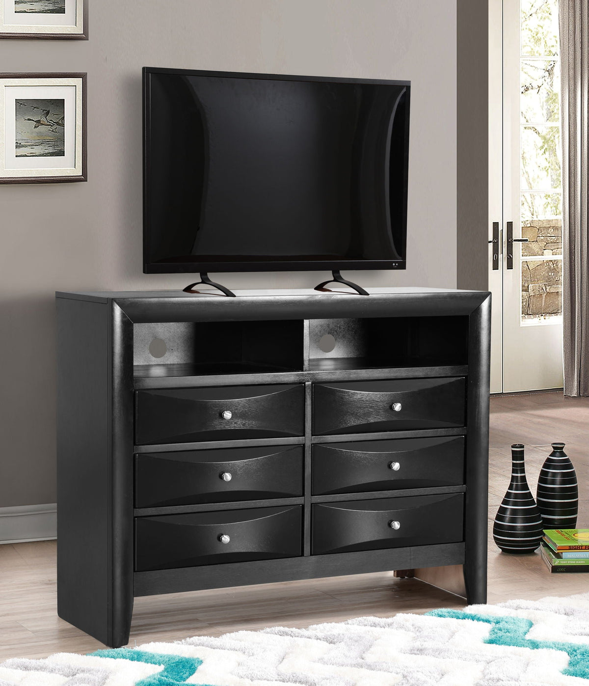 Media chest with modern beveled drawer fronts in black finish supporting a flat-screen TV on Tampa Home & Garden Store