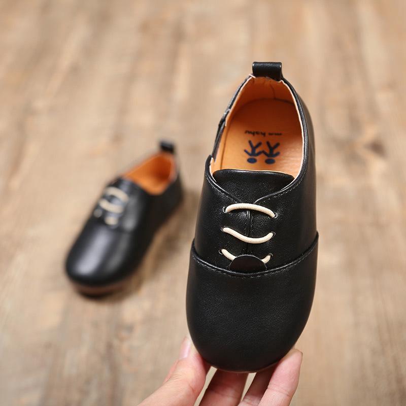 Stevvex black leather baby walking shoes, cream lace-up, orange lining, pair on display on Tampa Home & Garden Store