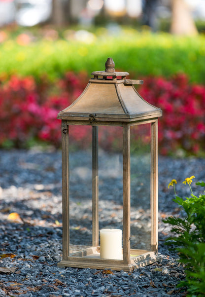 Ivory wood hurricane lantern with glass panels and candle inside on garden gravel on Tampa Home & Garden Store