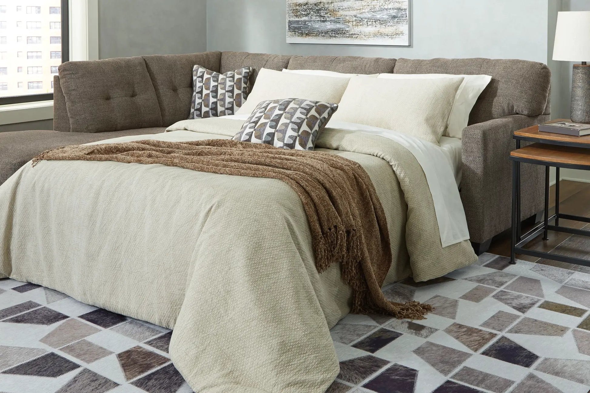 Mahoney Sectional by Unique Piece Furniture brown stationary sofa with neutral bedding on Tampa Home & Garden Store