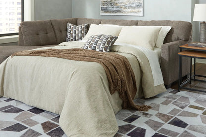 Mahoney Sectional by Unique Piece Furniture brown stationary sofa with neutral bedding on Tampa Home & Garden Store