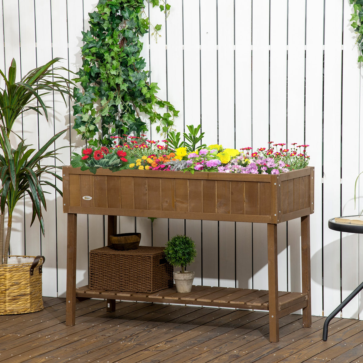 Raised garden bed with shelf and pockets in warm fir wood, filled with colorful flowers on Tampa Home & Garden Store