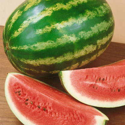 Crimson Sweet Watermelon with striped green rind and red flesh slices on a wooden table on Tampa Home & Garden Store