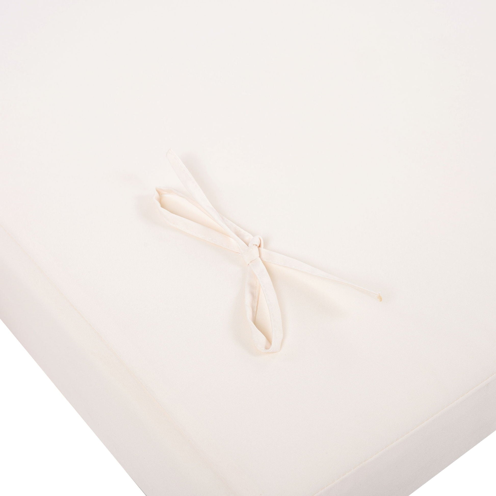 Chaises sunloungers empty shot on cream fabric backdrop with a pale ribbon bow on Tampa Home & Garden Store