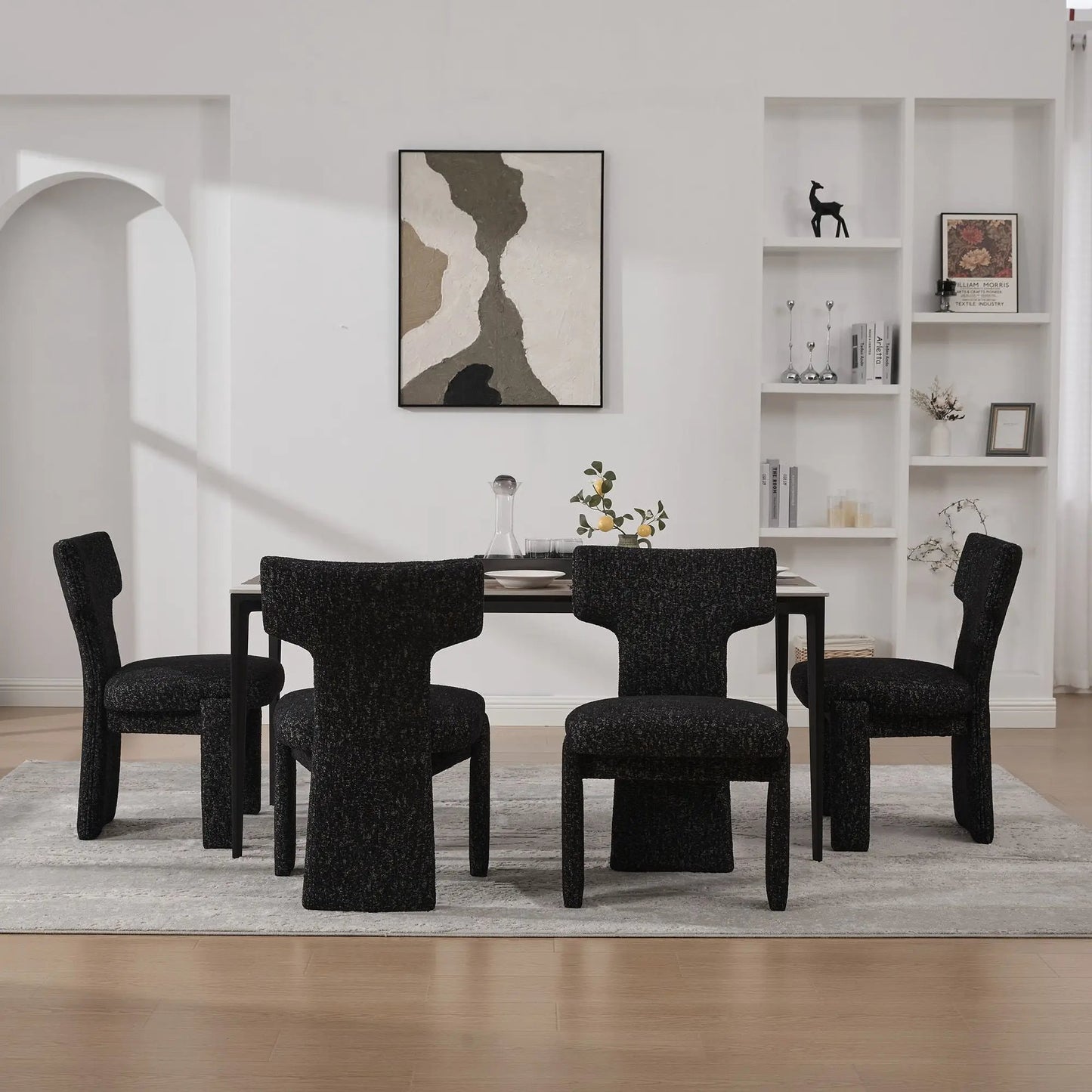 Six armless curved-back accent chairs in black textured fabric surround a dining table on Tampa Home & Garden Store