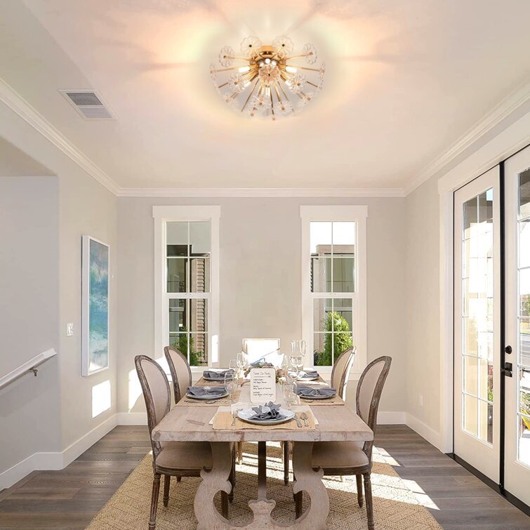 Gold flush mount ceiling light with crystal accents over a wooden dining table in a bright room on Tampa Home & Garden Store