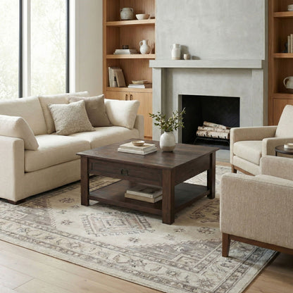 Monroe solid acacia side table in dark wood in a living room beside a beige sofa and fireplace on Tampa Home & Garden Store
