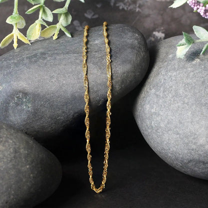 10k yellow gold Singapore chain necklace 1.80 mm by Bids.com, two chains displayed on rocks on Tampa Home & Garden Store