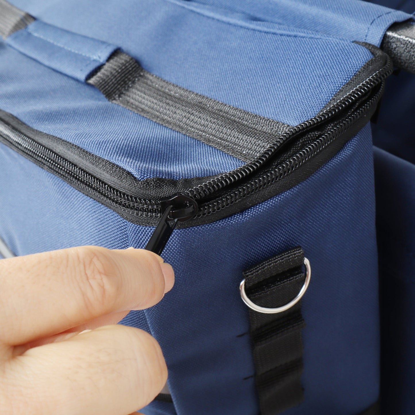 Outdoor wagon storage bag closeup in blue fabric with heavy-duty black zipper and metal D-rings on Tampa Home & Garden Store