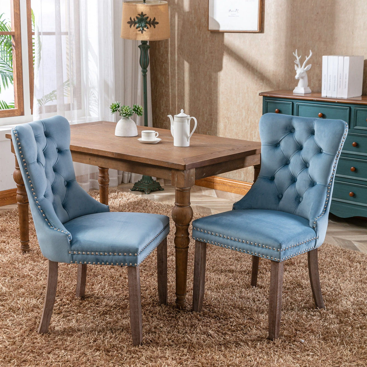 Tufted velvet dining chairs in blue with nailhead trim, set of 2 around a wooden table on Tampa Home & Garden Store